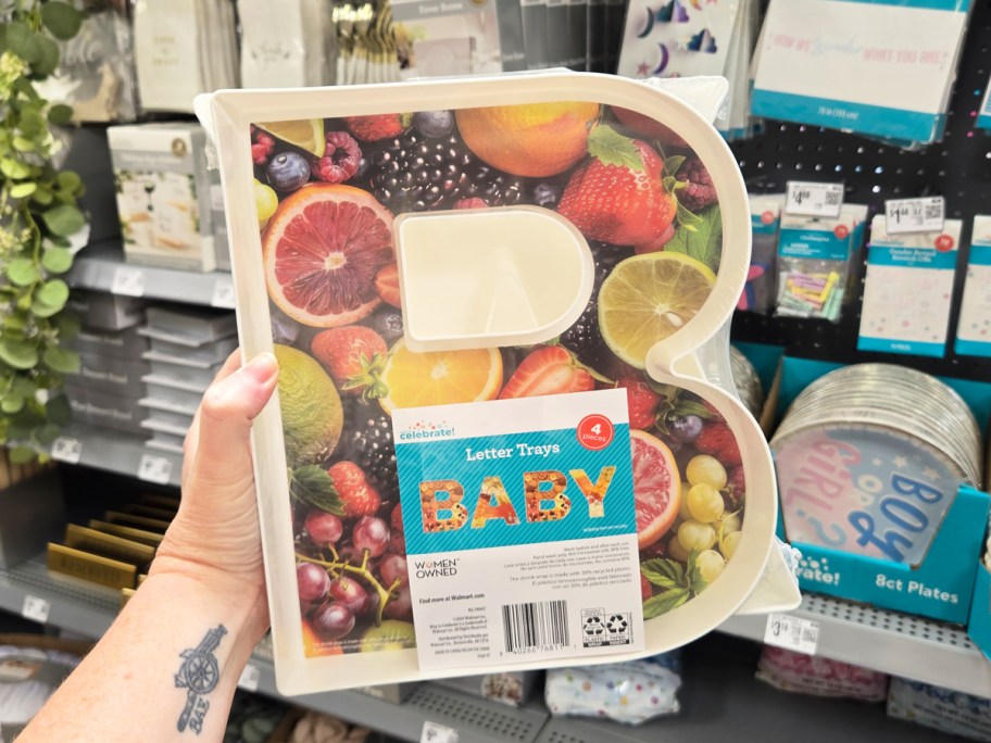 hand holding up a set of fillable trays in the shape of letters that spell BABY
