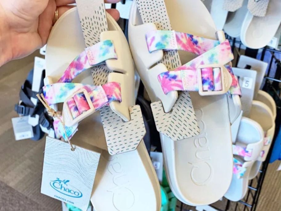 Hand holding a pair of Chacos Chillos sandals