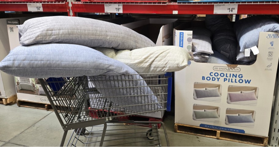 three different color cooling pillows inside of a sams club shopping cart in front of the display 