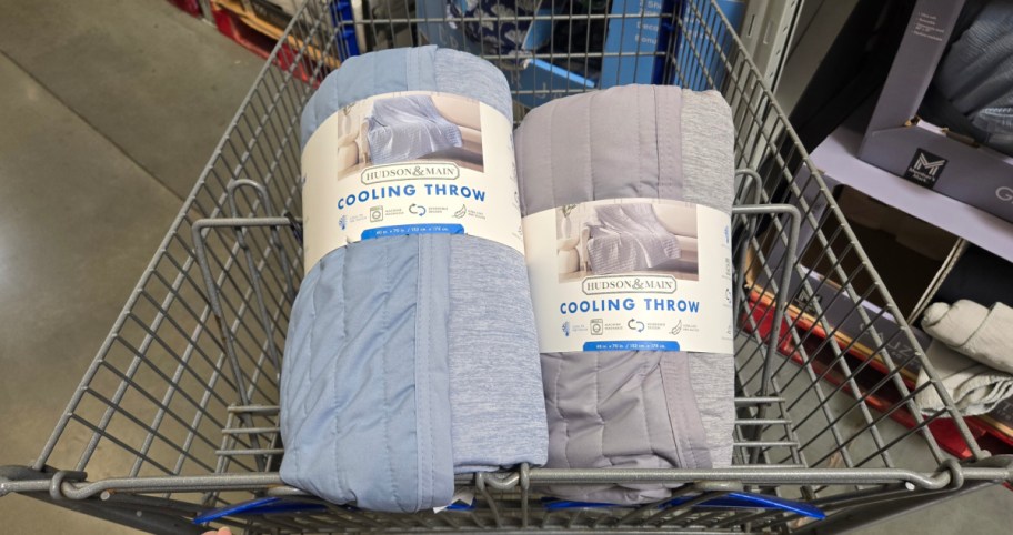 two different color cooling throws displayed inside of a sams shopping cart 