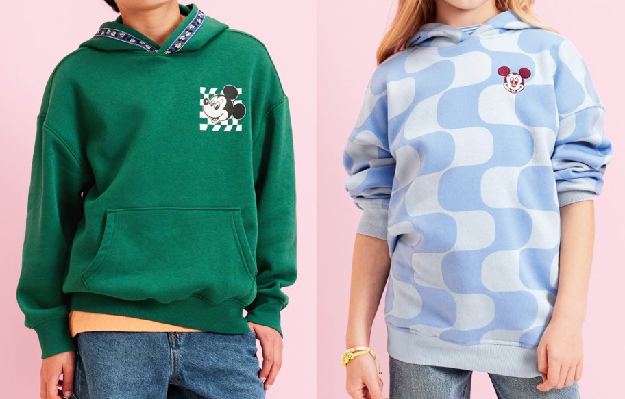 two kids in green and blue disney sweatshirts