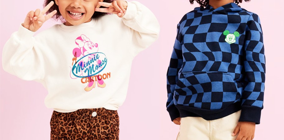 two kids in white and blue disney sweatshirts