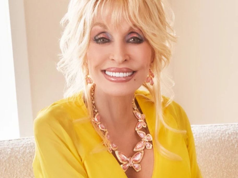 Dolly Parton wearing a butterfly necklace
