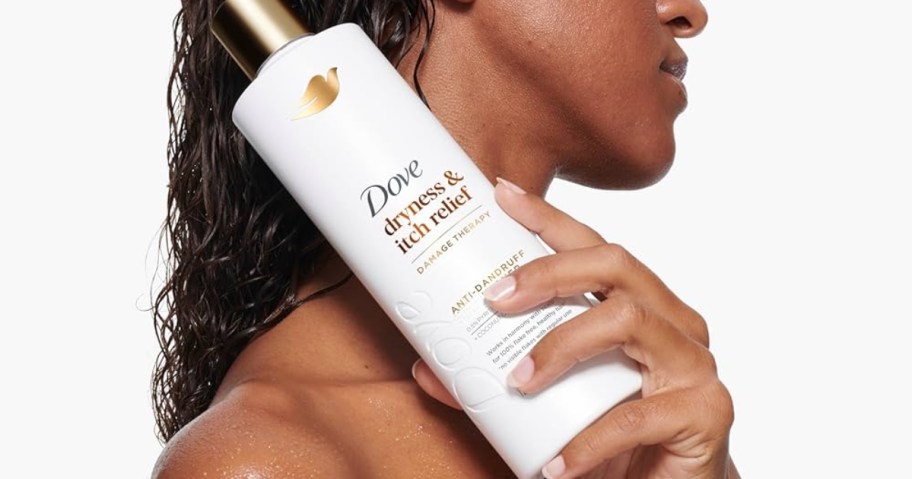 woman holding dove dryness and itch relief hair care bottle