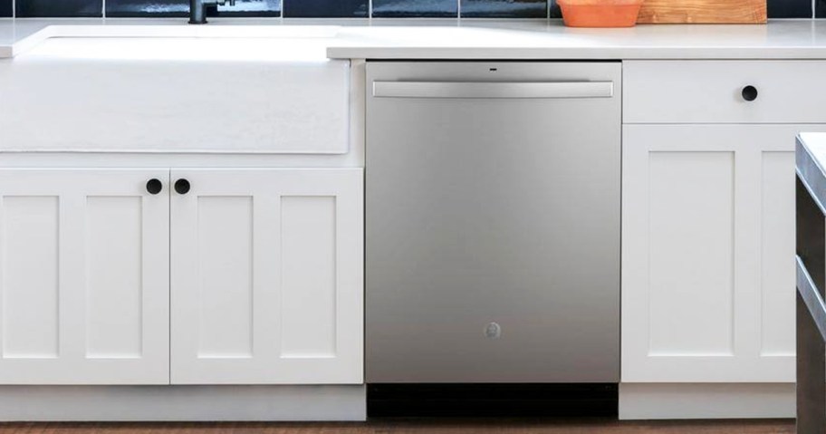 stainless steel dishwasher in kitchen with white cabinets