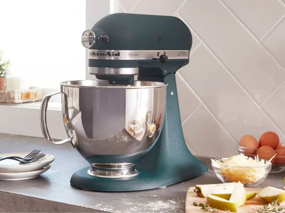 A gorgeous Hearth & Hand w/ Magnolia KitchenAid 5-Quart Stand Mixer on a countertop with baking substances surrounding it. 