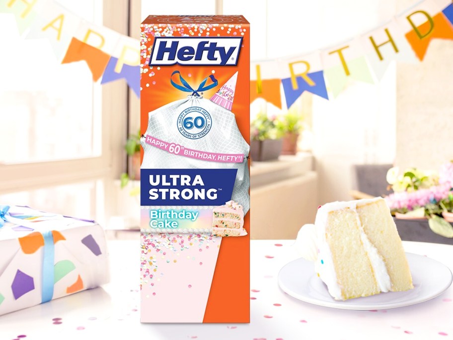 box of Hefty Birthday Cake Trash Bags on table next to a slice of cake