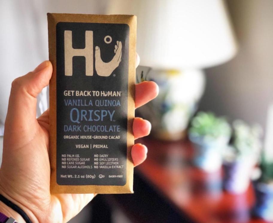 hand holding hu chocolate bar