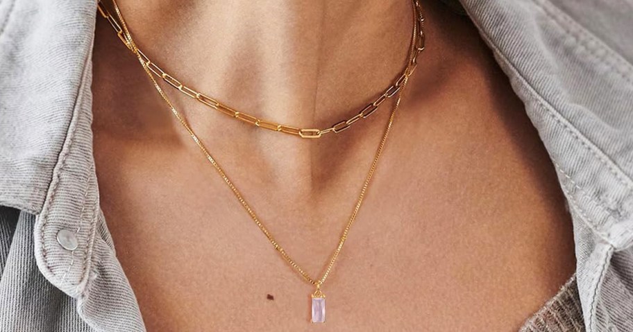 woman wearing a layered necklace with tourmaline pendant 