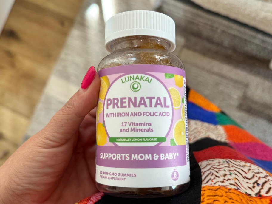 hand holding prenatal gummies in womans hand