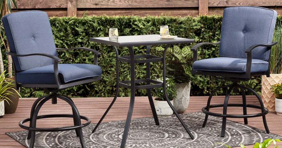 two patio chairs with blue cushions and matching table