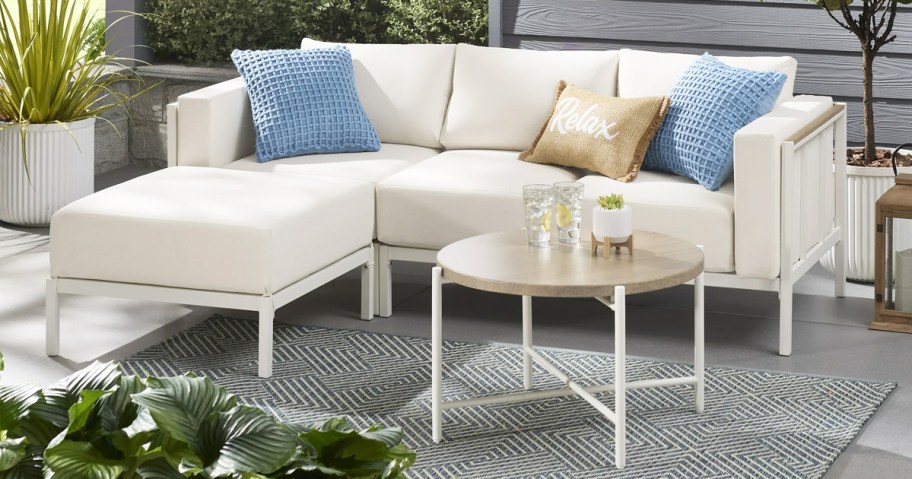 white patio sectional with a white coffee table