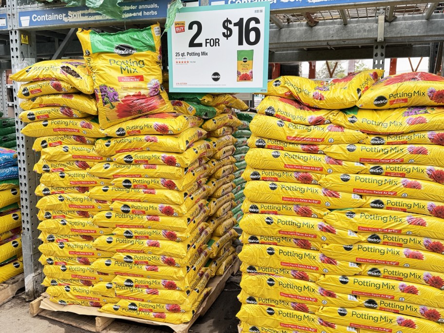 stacks of yellow bags of Miracle-Gro 25-Quart Potting Mix at Home Depot