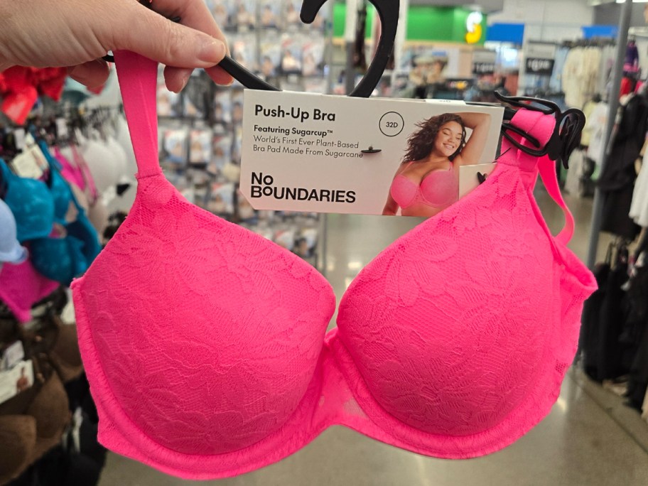 No Boundaries All Over Lace Push Up Bra with Sugarcup in hot pink being held in a walmart