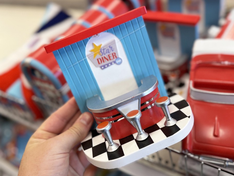 hand holding a retro diner figurine