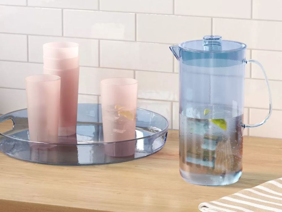 Rooms Esentials pitcher and tray in blue with water and ice inside 