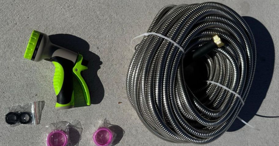 A stainless steel garden hose with nozzle and gaskets