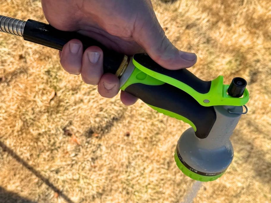 Hand spraying a nozzle on a stainless steel hose