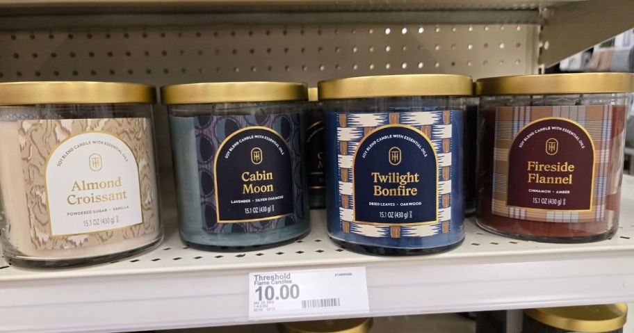 4 jarred candles on a store shelf