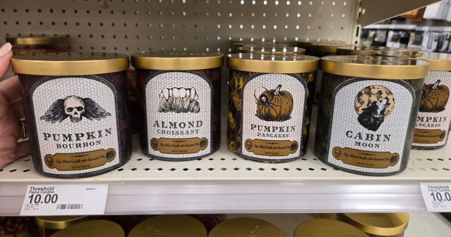 4 jarred candles on a store shelf