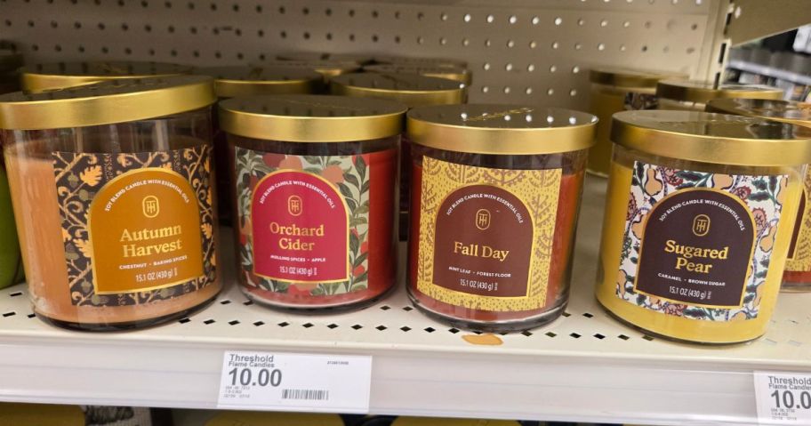 4 jarred candles on a store shelf