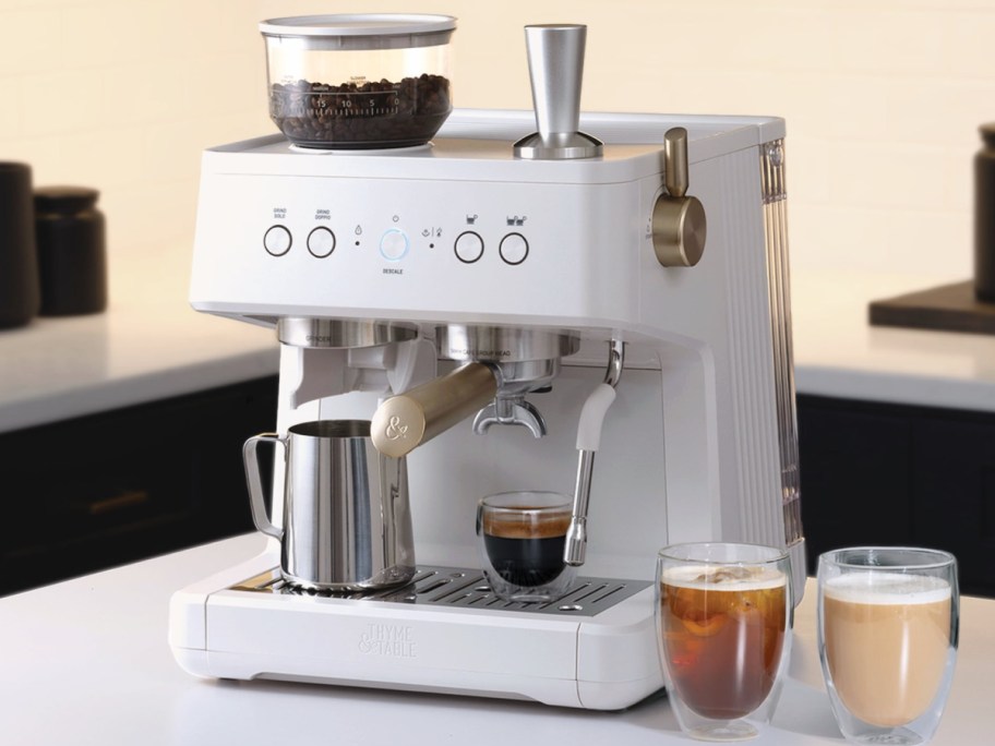 Barista espresso machine with all items shown including coffee grounds, frothier, and two dfferent coffees on the side