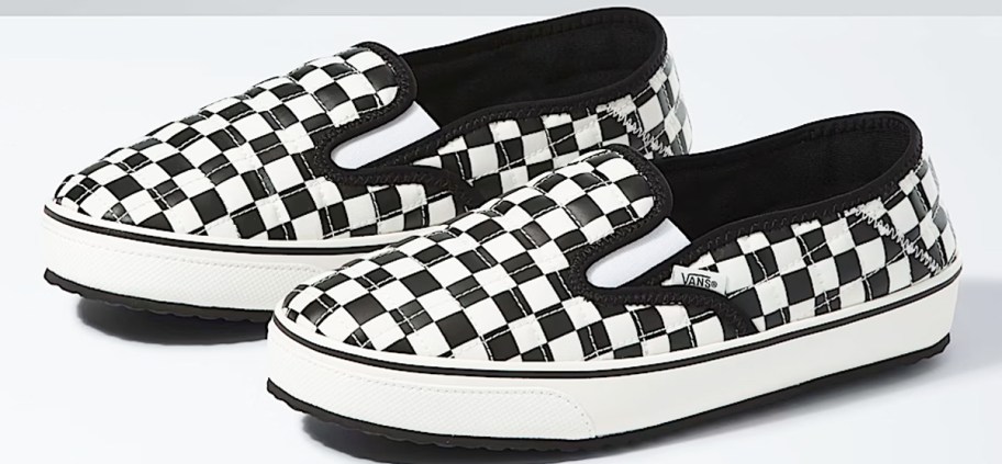 pair of black and white checkered print slip-on sneakers