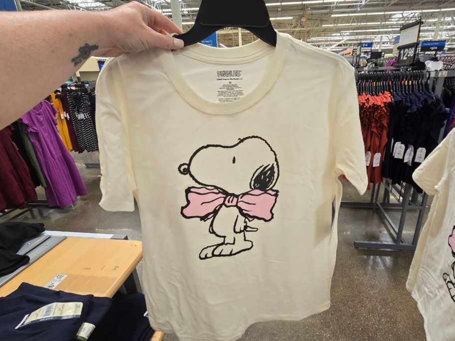 A snoopy graphic tee on a henger