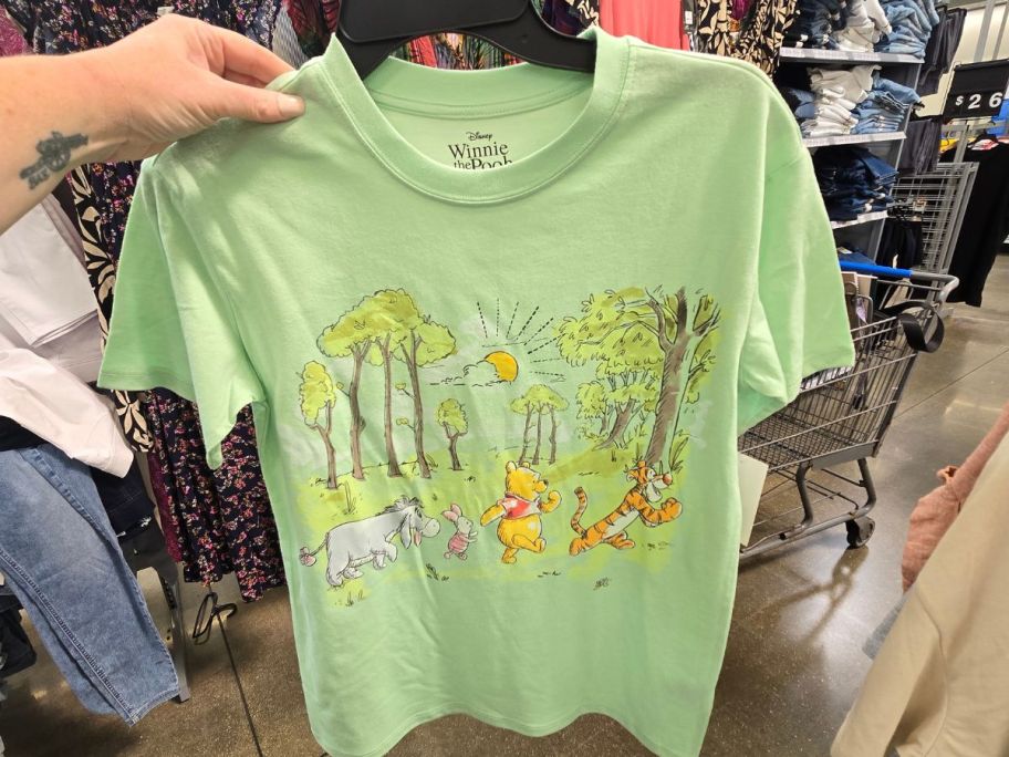 A winnie the pooj graphic tee on a hanger