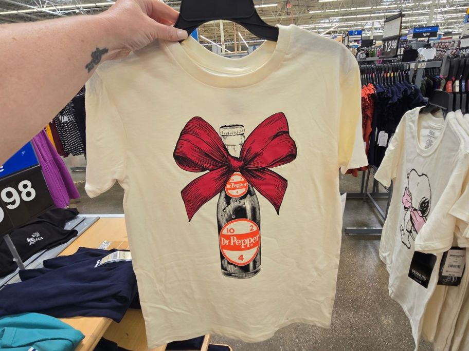 A dr pepper graphic tee on a hanger