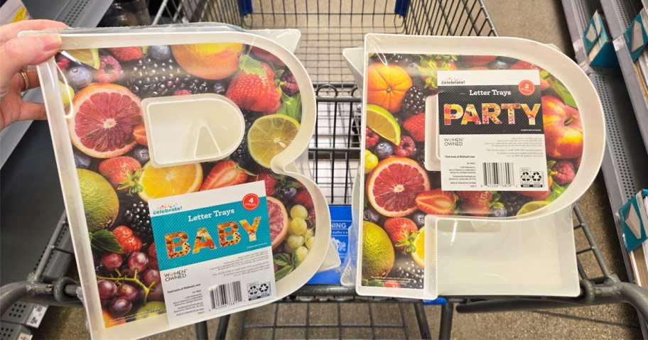 hand touching sets of letter trays that spell BABY and PARTY