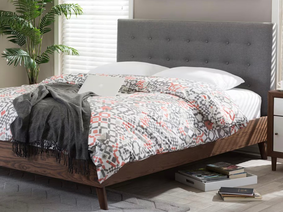 gray bed with floral comforter