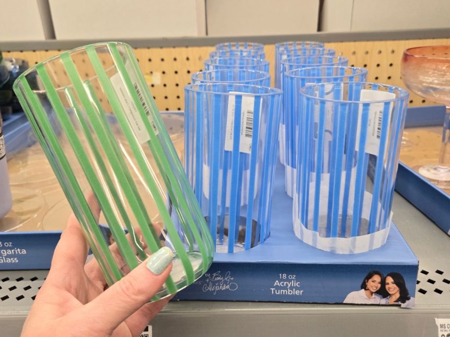 hand holding green striped Mainstays by Becky G. & Alejandra Tall Acrylic Tumbler in store