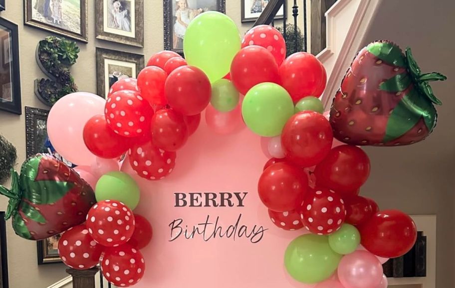 red green and pink strawberry themed balloon arch kit assembled
