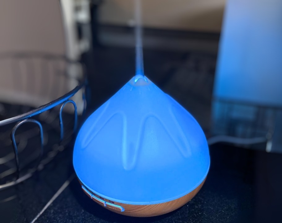 an aromatherapy diffuser with a blue led light
