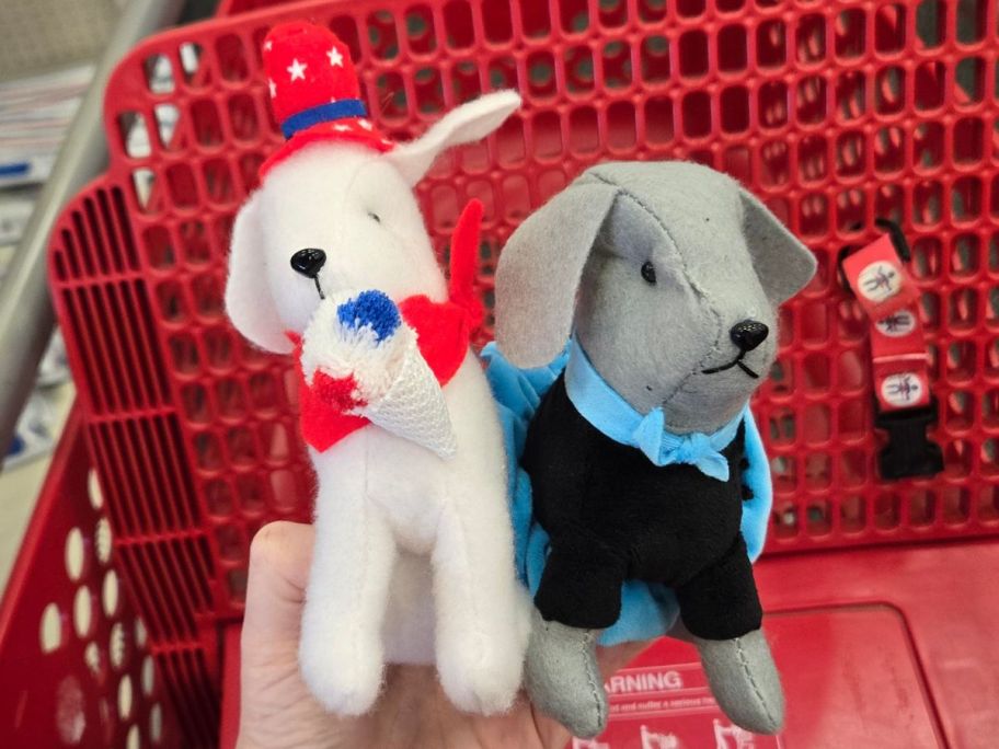 two Plush Dogs in hand in store