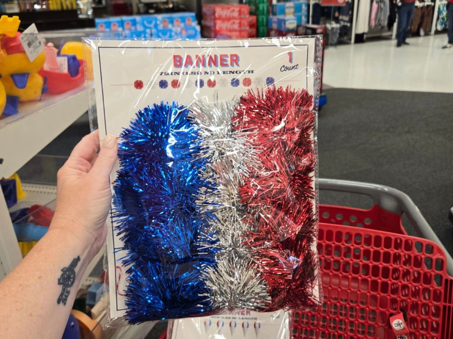 blue, white, and red Garland Banner in hand in store