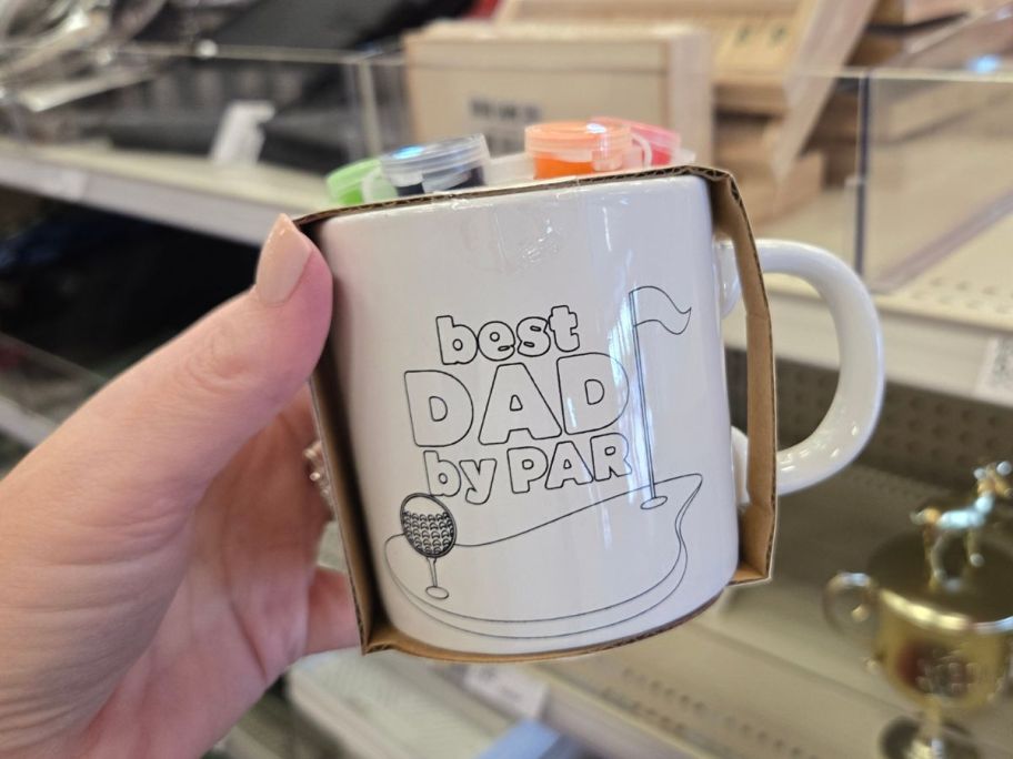 Best Dad by Par Coffee Mug in hand in store