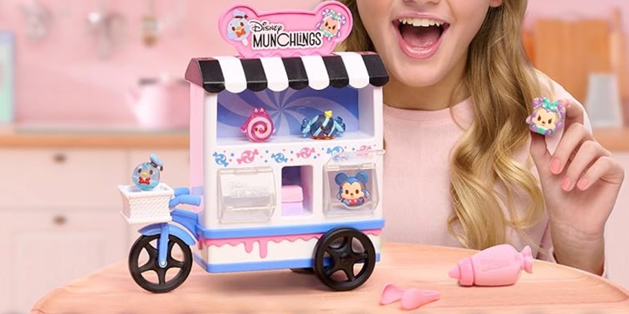 girl playing with disney munchlings cart and toy set 