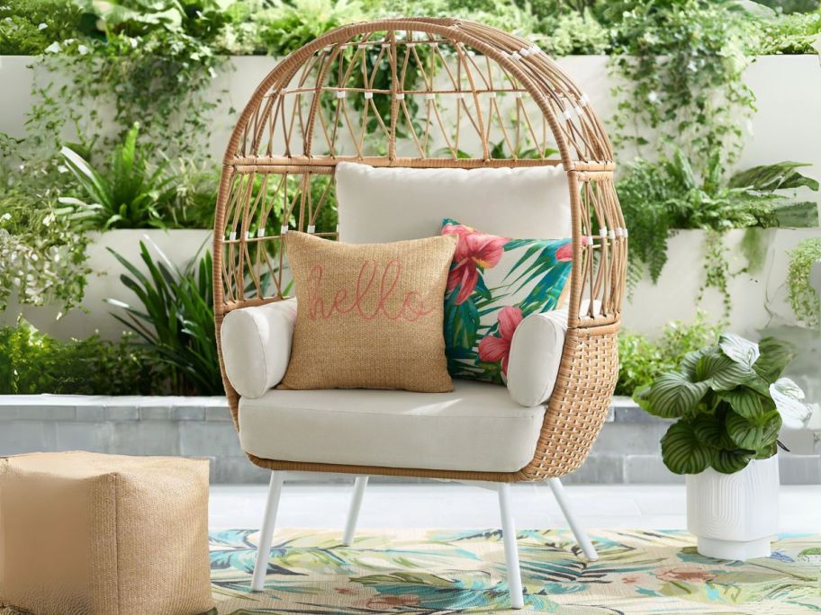 Better Homes & Gardens Lilah Boho Outdoor Wicker Egg Chair on patio with pillows on it