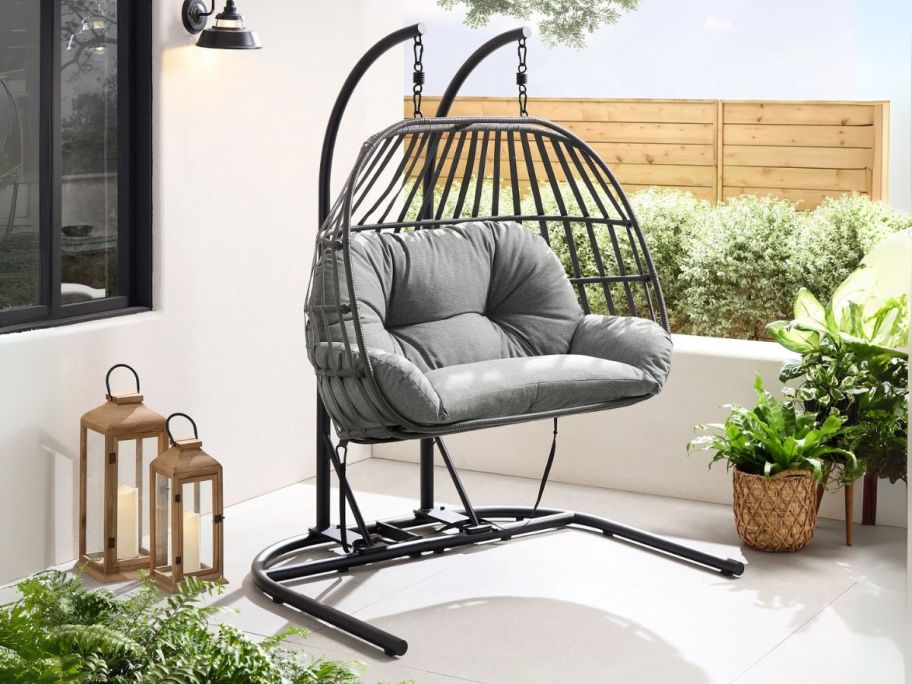 grey and black Mainstays Outdoor Wicker Patio Double Hanging Egg Chair on patio