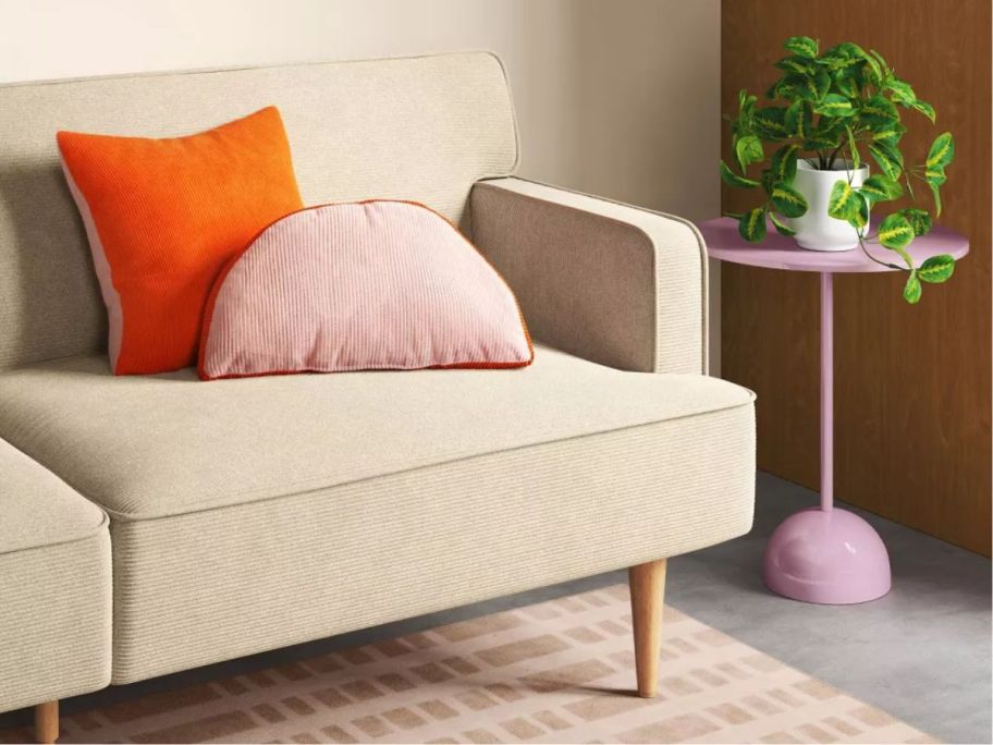 pink Room Essentials Pedestal Table next to couch