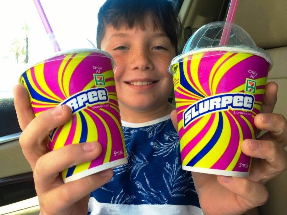 aa boy holding two to go cups with lids and straws