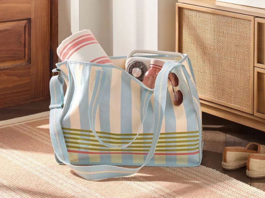 Hearth & Hand with Magnolia Cross Stripe Carry-All Tote with beach items in it on floor in entryway