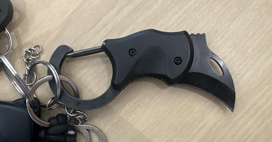 black compact keychain knife on a table