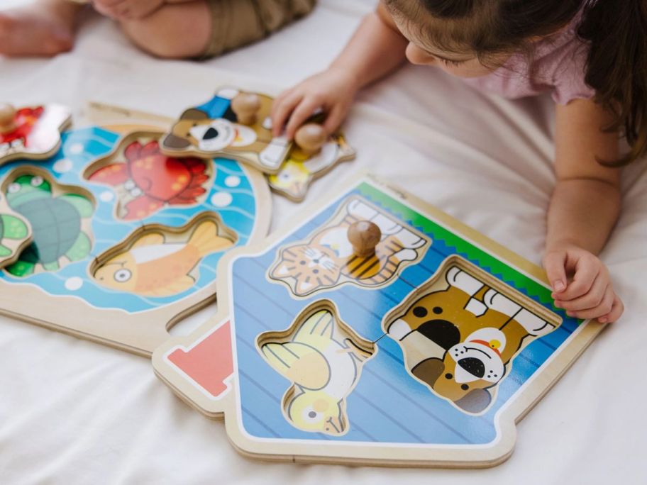 kids playing with Melissa & Doug Animals Jumbo Knob Wooden Puzzles Set