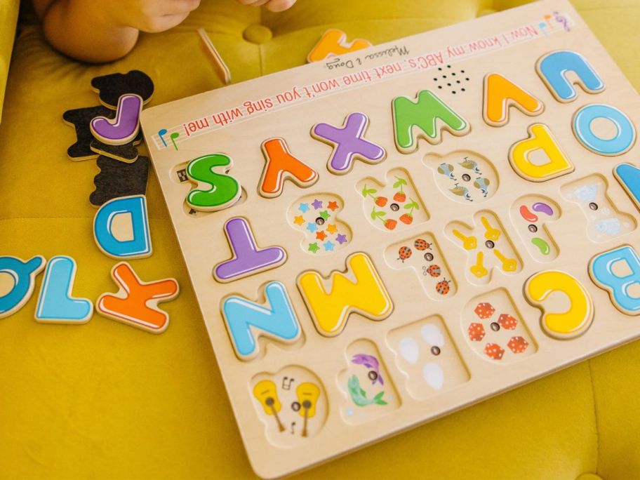 kid playing with Melissa & Doug Wooden Alphabet Sound Puzzle