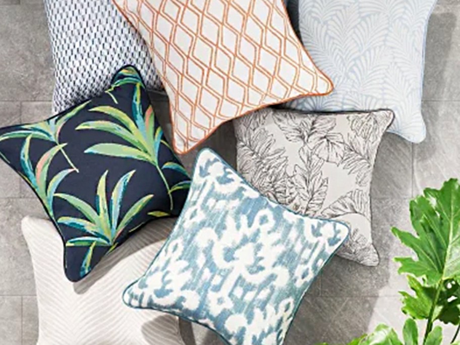 floral and print pillows laying in a pile 