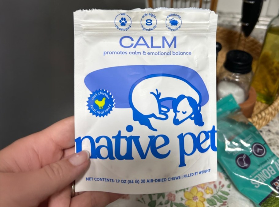 person holding bag of native pet calming dog chews