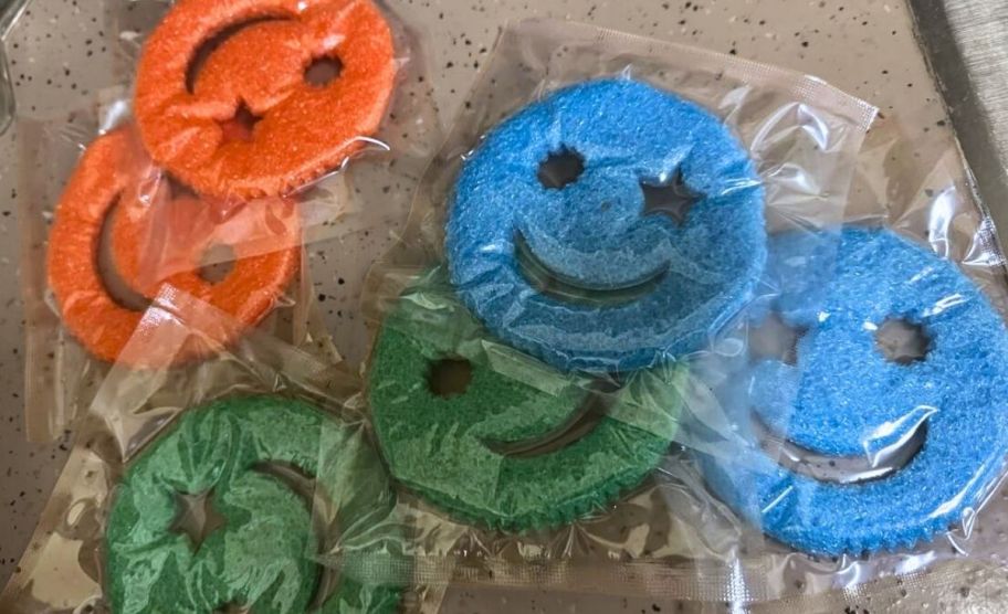 six smile sponges with 2 in each in orange, blue, and green